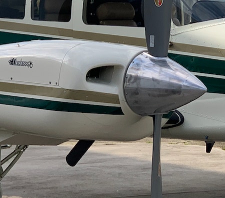 Propeller of contemporary private prop aircraft parked on airfield on sunny clear day